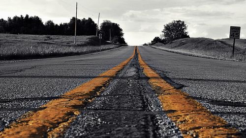 Empty road along trees