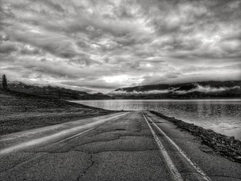 Road by landscape against sky