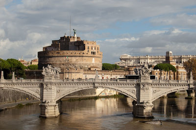 View of bridge over river against cloudy sky