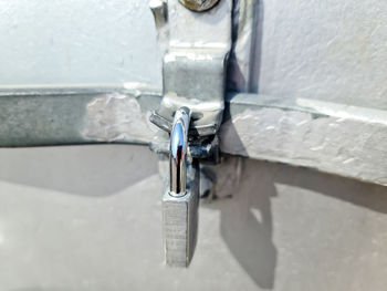 High angle view of padlocks hanging on wall