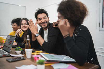 Happy colleagues in conference room