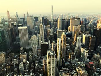 Aerial view of modern buildings in city against sky