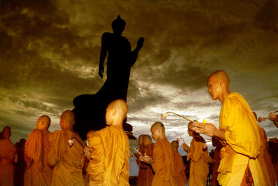 People standing in water against sky