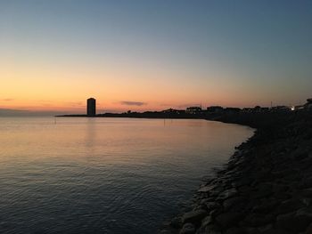 Scenic view of sea against clear sky during sunset