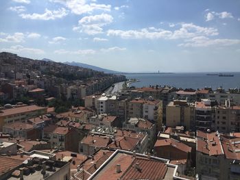 High angle view of townscape by sea against sky