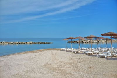 Scenic view of beach against blue sky