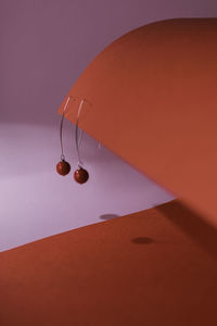Modern stud geometric earrings on red paper background.