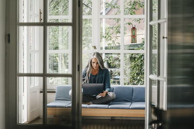 Man sitting on table at home