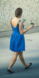 Full length of woman standing by railing