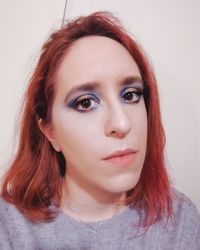 Close-up portrait of beautiful young woman over white background