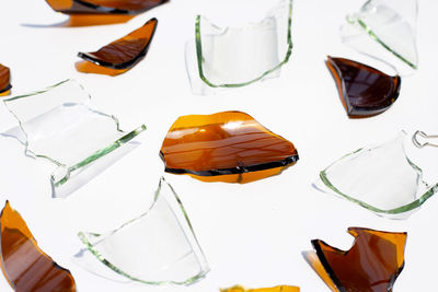 High angle view of umbrellas on table against white background