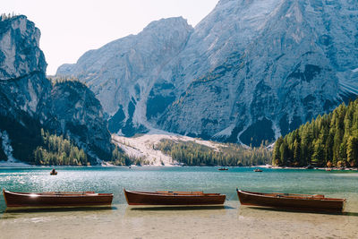 Scenic view of lake by mountains against sky