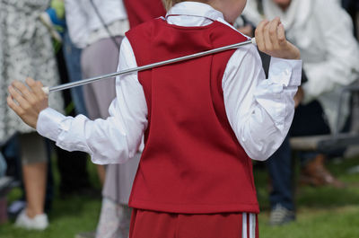 Midsection of man holding umbrella