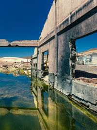 View of abandoned building against blue sky