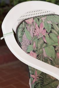 Floral pattern cushion on plastic chair