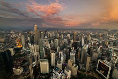 Aerial view of cityscape against sky during sunset