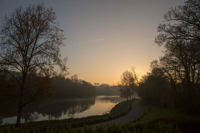 Scenic view of lake against sky during sunset