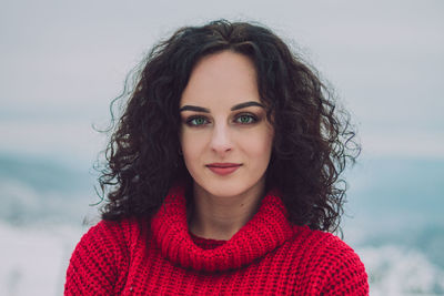 Portrait of smiling young woman standing outdoors