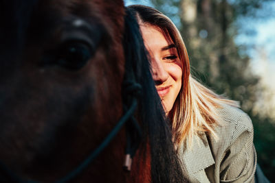 Smiling woman sitting on horse