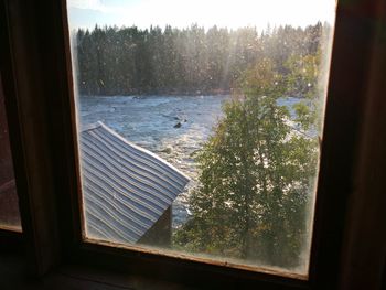 Scenic view of lake seen through window