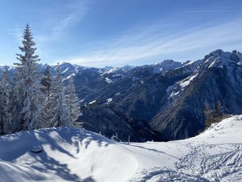 Scenic view of snow covered mountains against sky