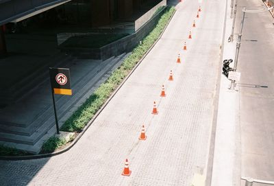 High angle view of road sign on street in city
