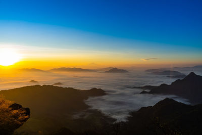 Scenic view of silhouette mountains against sky during sunset