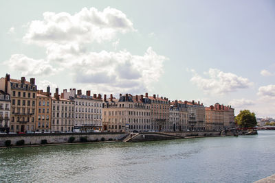 Buildings against cloudy sky