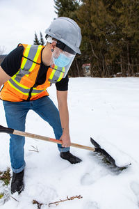 Full length of man standing on snow covered land