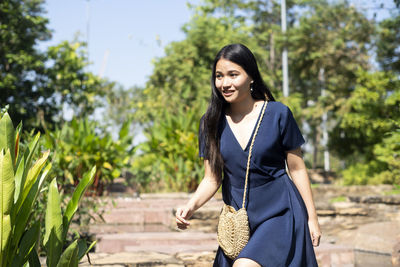 Smiling woman walking at park