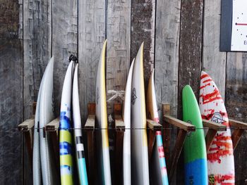 Surfboards leaning on wooden wall