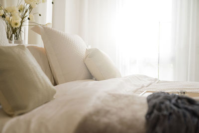 Midsection of man relaxing on bed at home