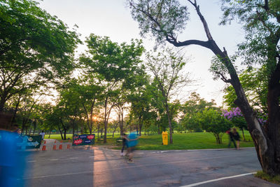 Rear view of people on road in park