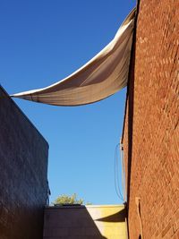 Low angle view of building against clear blue sky