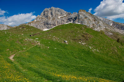 Scenic view of land and mountains against sky