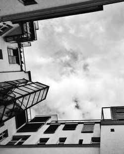 Low angle view of building against cloudy sky