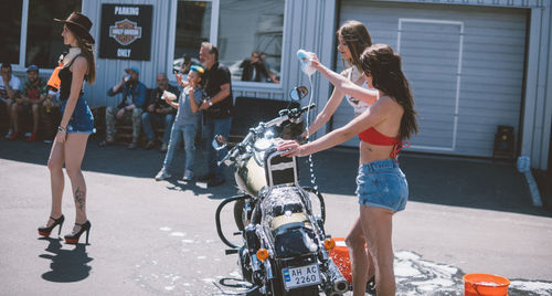 People riding motorcycle on street in city