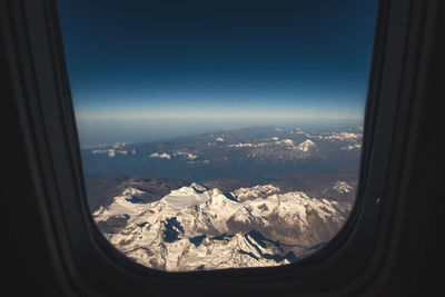 Aerial view of landscape seen through airplane window