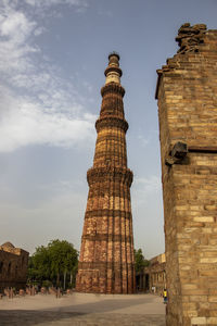 Low angle view of historical building qutab minar against sky