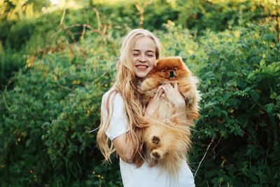 Portrait of young woman with dog