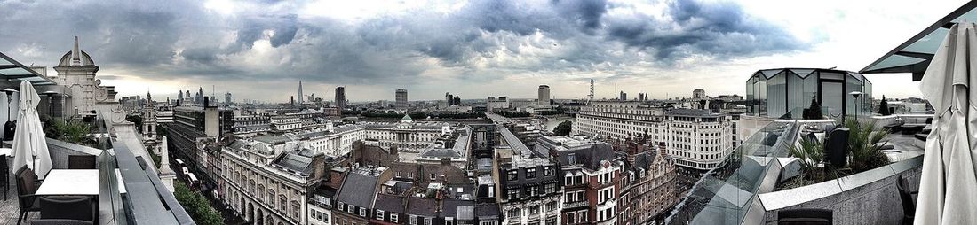 Buildings against cloudy sky