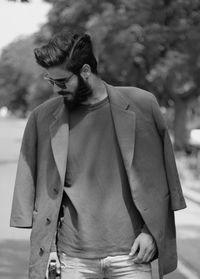 Fashionable young man standing on road