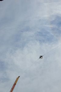 Low angle view of amusement park ride against sky