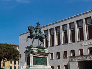 Low angle view of statue against blue sky