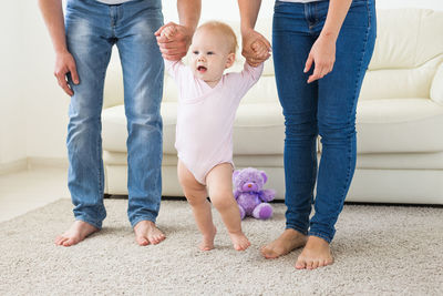 Parents playing with daughter at home