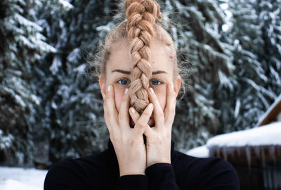 Portrait of woman with snow covered hand
