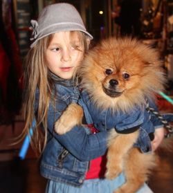 Girl with pomeranian looking away