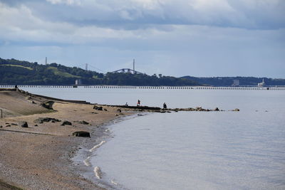 View of beach against cloudy sky