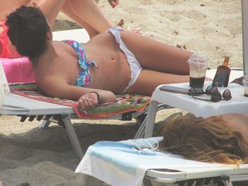 Rear view of woman sitting on bench