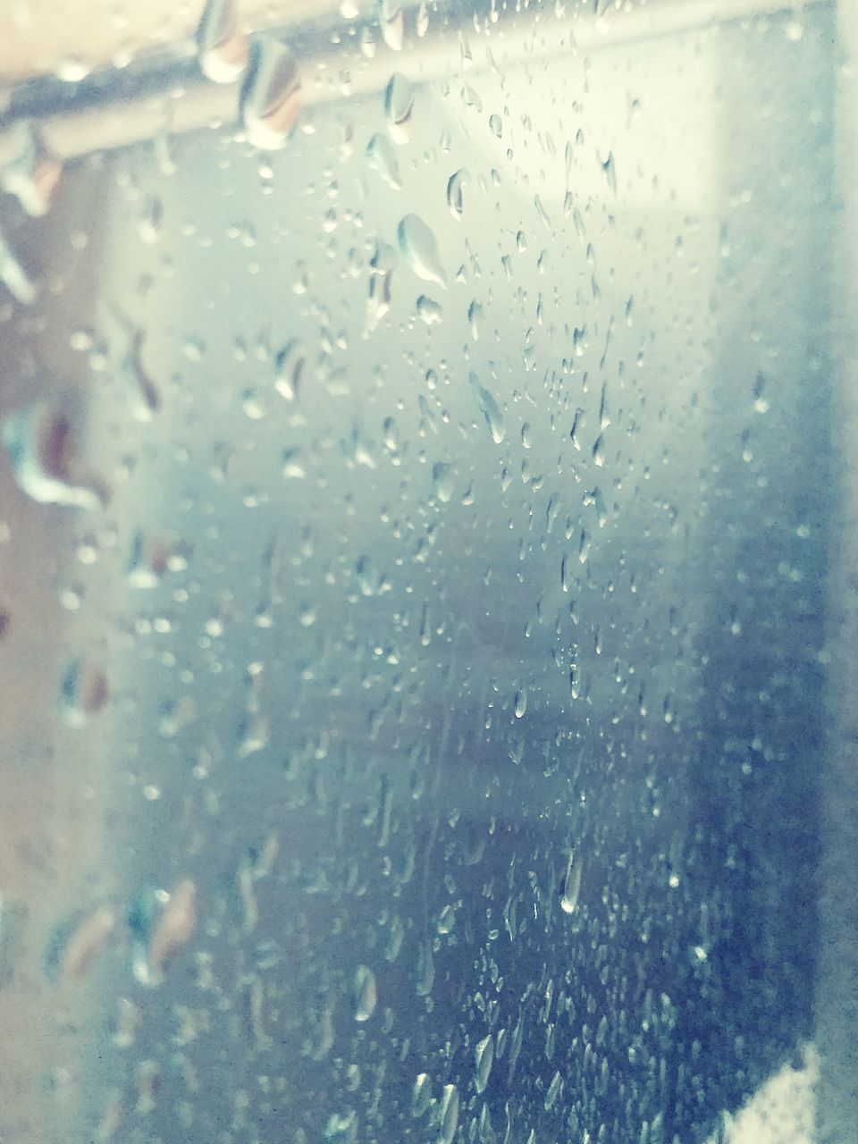 FULL FRAME SHOT OF WET GLASS WINDOW IN RAINY SEASON